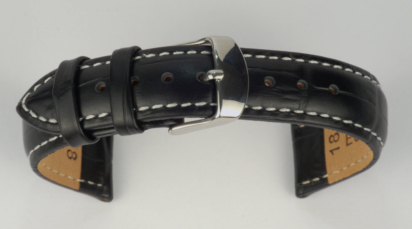 Lederuhrenarmband (Schwarz mit weißer Naht) zu einem Bogen geformt mit weißem Hintergrund. Detaillierte Nahaufnahme.