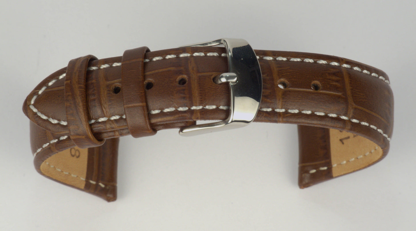 Lederuhrenarmband (Dunkelbraun mit weißer Naht) zu einem Bogen geformt mit weißem Hintergrund. Detaillierte Nahaufnahme.