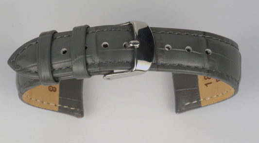 Lederuhrenarmband (Dunkelgrau) zu einem Bogen geformt mit weißem Hintergrund. Detaillierte Nahaufnahme.