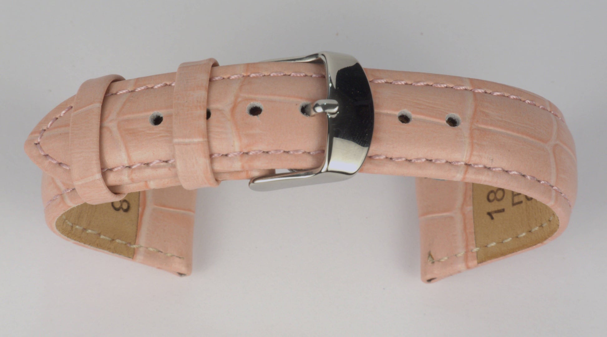 Lederuhrenarmband (Pink) zu einem Bogen geformt mit weißem Hintergrund. Detaillierte Nahaufnahme.