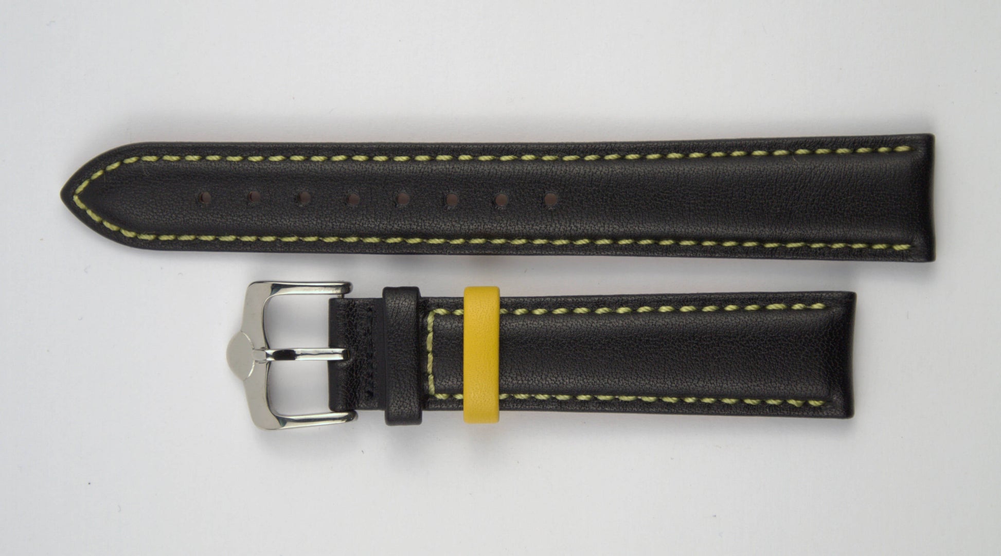 Lederuhrenarmband (Schwarz mit gelber Naht) flach aufgelegt mit weißem Hintergrund. Detaillierte Nahaufnahme.